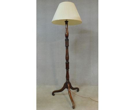 An early 20th century mahogany standard lamp with turned column on tripod cabriole supports. H.184cm 