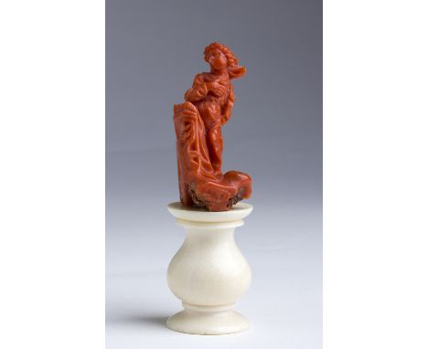 "Virgin Annunciated". A carved coral figure  -  Trapani (Itay), late 17th Century; ; on a ivory base. 10 cm, 3 15/16 in high 