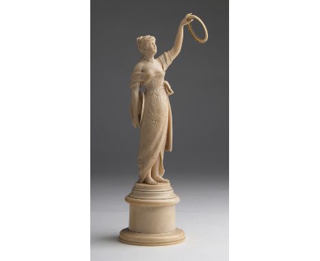 A carved ivory figure of a young lady - France,  late 19th / early 20th Century (pre-1947); ; on a ivory base. 25.5 cm, 10 3/