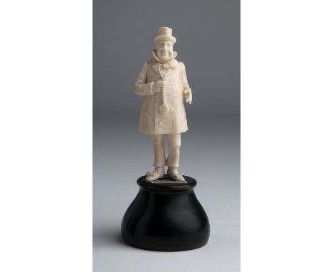 “Wilkins Micawber”. A carved ivory figure - England, late 19th Century; ; labelled: "Micawber", on a wooden base. 14.2 cm, 5 