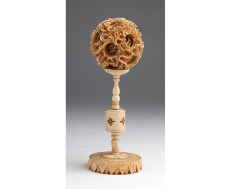 A carved ivory Dragon Puzzle ball with openwork dragon motifs - China, late XIX Century; ; 19.6 cm, 7 23/32 in high, ball dia