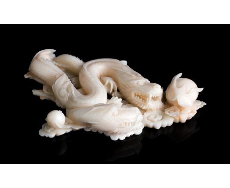 A carved coral sculpture depicting two dragons - China, 20th Century (pre-1947); ; 13.2 x 9.5 cm, 5 13?64 x 3 47?64 in, weigh
