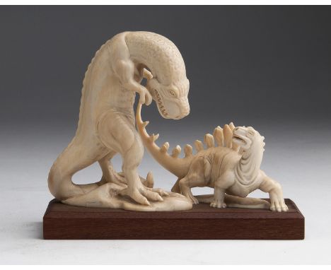 A carved ivory figural group depicting two dinosaurs - probably China, early 20th Century (pre-1947); ; on a wooden base. 11.