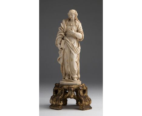 "Saint Barbara". A carved ivory figure - France,  late 17th Century; ; on a gilded wood base. 26 cm, 10 15/64 in high overall