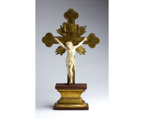 A carved ivory Crucifix - France, late 18th / early 19th Century; ; standing on a gilt wood plinth base. 39 cm, 15 23?64 in h