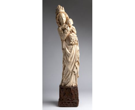 "Virgin and Child". A carved ivory neo-Gothic figural group  - probably France, 18th Century; ; on a carved wooden base. 75.5