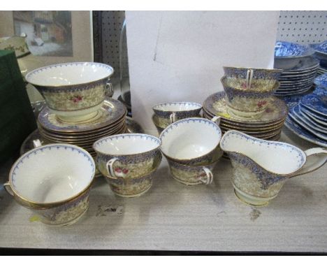 A Royal Worcester tea set, comprising 12 cups, saucers, side plates, two sandwich plates, sugar bowl and milk jug, decorated 