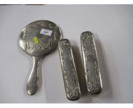 A hallmarked silver three piece dressing table set, with engine turned decoration and ribbon swags