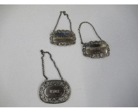 Two hallmarked silver bottle tickets, Brandy and Whisky, together with another bottle ticket