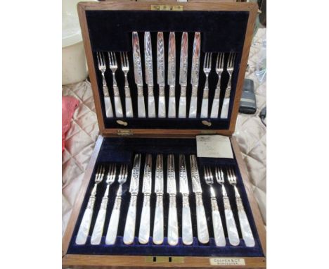 An EPNS and mother of pearl twelve piece fruit knife and fork set, with engraved decoration, in an oak case