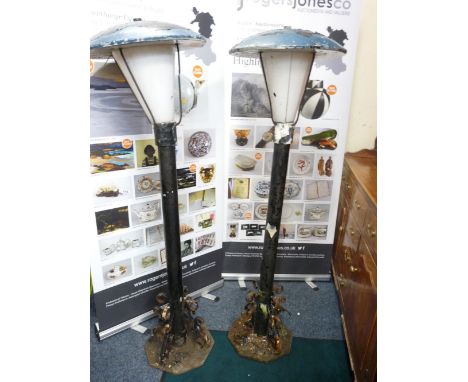TWO GARDEN/STREET STYLE LAMPS in cast galvanized and wrought iron metal with domed top lamp covers and white plastic shades, 