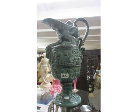 A tall green ceramic Baccanalia style ewer, a/f. COLLECT ONLY.