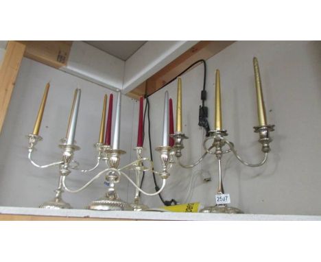 Four silver plate candelabra.