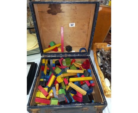 A vintage case of playworn wooden vintage blocks.