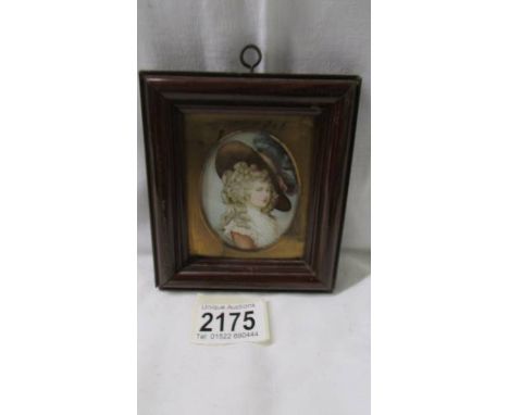 An old oval framed and glazed unsigned miniature portrait of a lady.