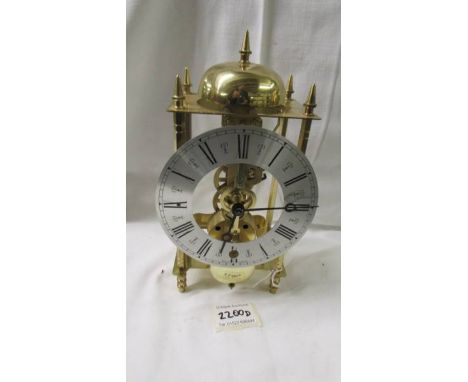 A modern brass 'Skeleton' style clock.