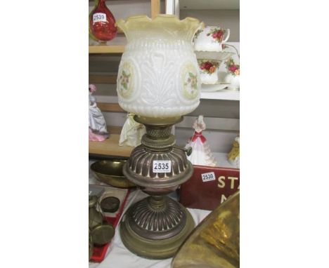 A Victorian brass oil lamp with later shade. COLLECT ONLY.