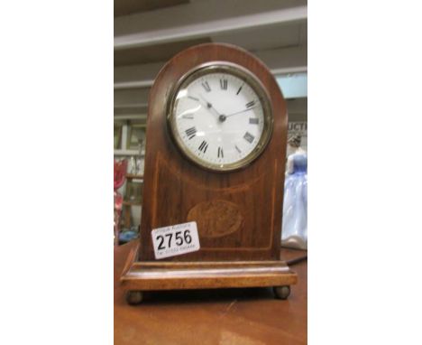 An Edwardian mahogany inlaid mantel clock in working order.