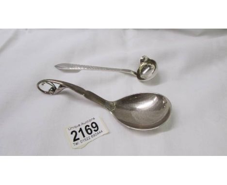 A Sterling silver spoon by Georg Jenson &amp; Wendel A/S and a small ladle (possibly silver).&nbsp;(22.5gm, Length 14.5cm)