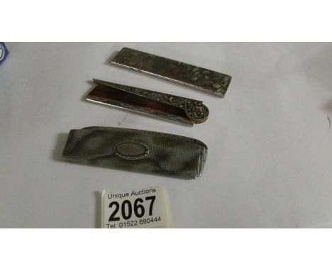 A vintage comb in a case and two other folding combs.