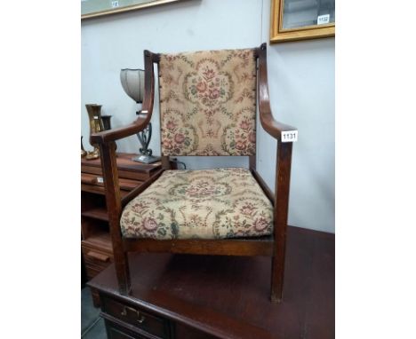 A 1930's oak arm chair with tapestry seat. COLLECT ONLY.