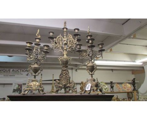 A pair of ormolu candelabra and one other. COLLECT ONLY.All are solid brass and substantially heavy. No visible damage or mis