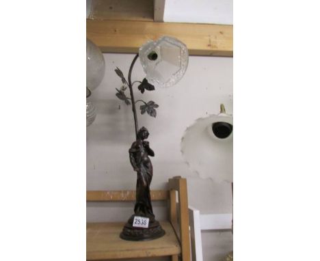 A figural table lamp with glass shade. COLLECT ONLY.