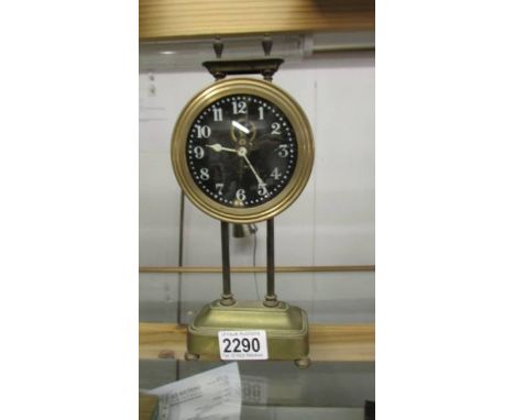 A Victorian brass Gravity clock, in working order.