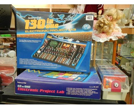 Two electronic project lab kits and a quantity of vintage Amiga discs.