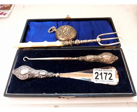 A cased silver handled shoe horn and button hook, a pickle fork and a modern pocket watch.