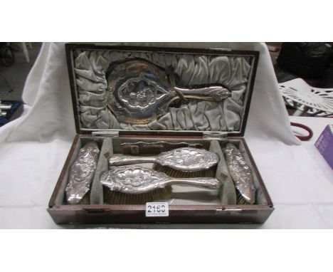 A cased 19th century silver set comprising 4 brushes, a comb and a hand mirror, WD Birmingham, 1863.