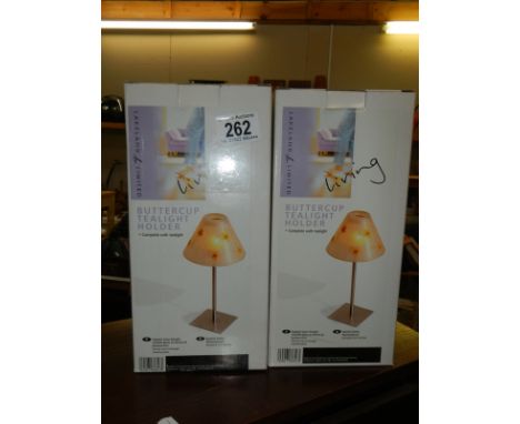 Two boxed Buttercup tea light holders.