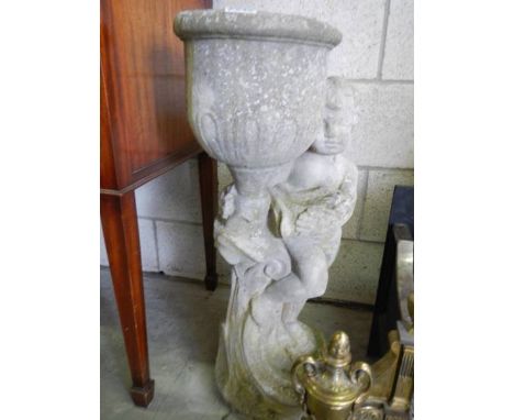 A tall garden planter on cherub base, 76cm tall, in good condition.