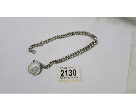A heavy old kerb link chain with a one shilling coin, dated 1895.