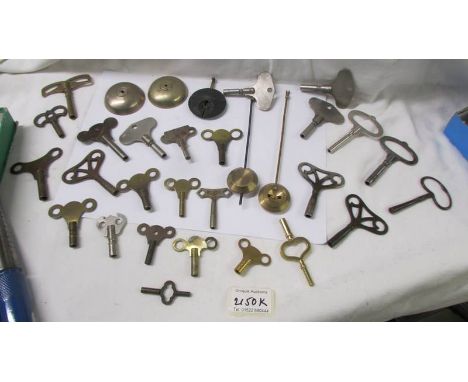 In excess of 28 old clock keys, pendulums and bells.
