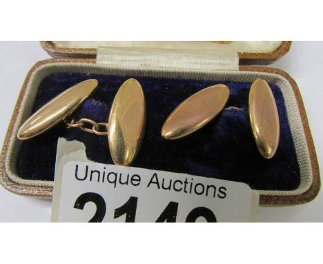 A pair of 15ct gold cuff links and a 15ct gold tie pin, 6.5 grams.