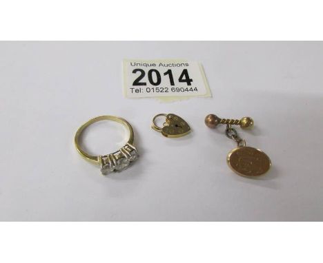 A gold ring, size U, a gold tie pin and a gold padlock. 7.9 grams.