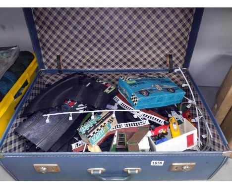A vintage case containing 1960's Scalextric including buildings and cars a/f