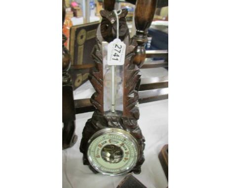 A Carved Black Forest barometer.