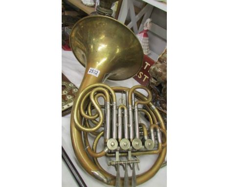 A rare rotary valve French Horn marked Alliance, La Fleur, has some dints but in good working order.