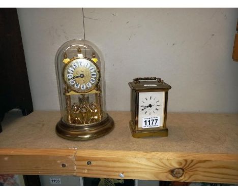 A brass Quartz carriage clock &amp; anniversary clock under glass dome