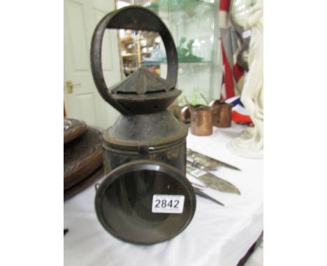 An old railway lamp with red and blue glass but clear glass missing.
