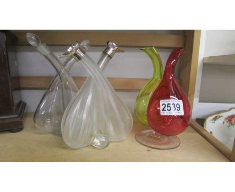 Three vintage oil and vinegar bottles.