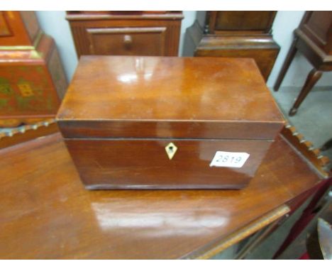 A mahogany tea caddy.