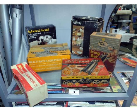 A quantity of vintage boxed kitchen items including Kenwood sausage filler etc