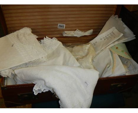 A vintage suitcase with vintage household linen, some embroidered, some with crochet edge trim etc., COLLECT ONLY.