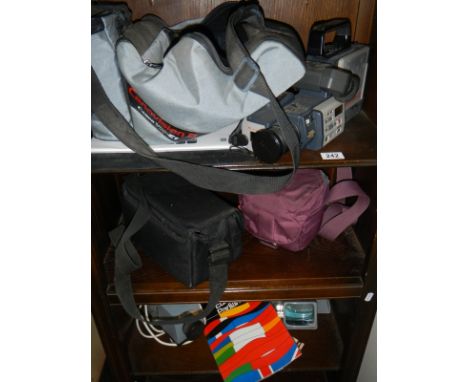 Three shelves of photographic items including projector, slides etc.,