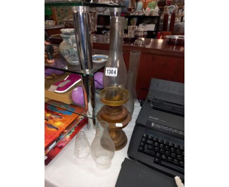 A brass oil lamp &amp; 4 glass chimneys