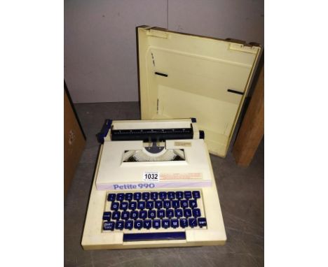 A Petite 990 vintage cased typewriter