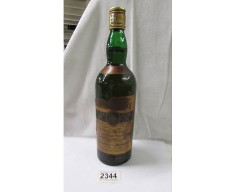 A bottle of Mackensie Scotch whisky.